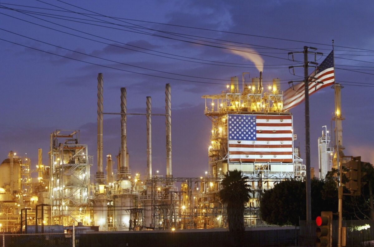 IHS, a research firm, said Wednesday that the increase in unconventional oil and natural gas production is boosting household disposable income. Above, a petroleum refinery in Wilmington.