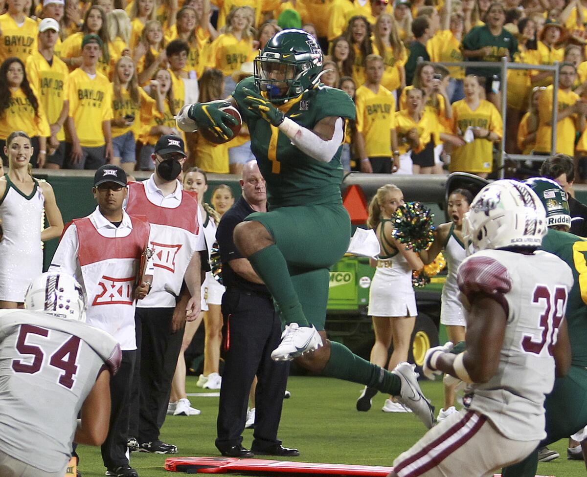Baylor running back Trestan Ebner (1) leaps into the end zone against Texas Southern in the second half of an NCAA college football game, Saturday, Sept. 11, 2021, in Waco, Texas. (Lauryn Amy/Waco Tribune-Herald via AP)