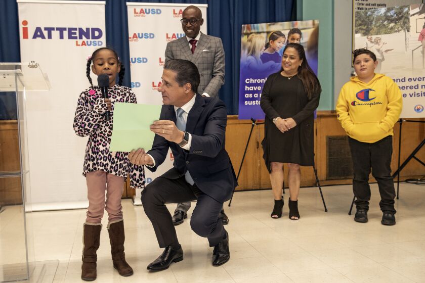 LOS ANGELES, CA-FEBRUARY 3, 2023:LAUSD Superintendent Alberto Carvalho holds a paper written by 4th grader Tinniya Wilson as she reads her prepared remarks addressing the media about the benefits of having a tutor and mentor during a press conference at Compton Ave. Elementary School STEAM Academy in Los Angeles. In background from left to right are Andre Spicer, LAUSD Region South Interim Superintendent, Denise Miranda, Ed.D. Director for LAUSD, and Michael Arrellano, a 4th grader at the school who also benefited from having a tutor. Carvalho announced a new mentoring initiative, Everyone Mentors LA, during the press conference. The mentoring initiative will invest in the lives of historically underserved students. It will match students contending with declining grades, chronic absenteeism, social emotional support and other challenges that have inhibited their academic success with a mentor from the Los Angeles community. (Mel Melcon / Los Angeles Times)