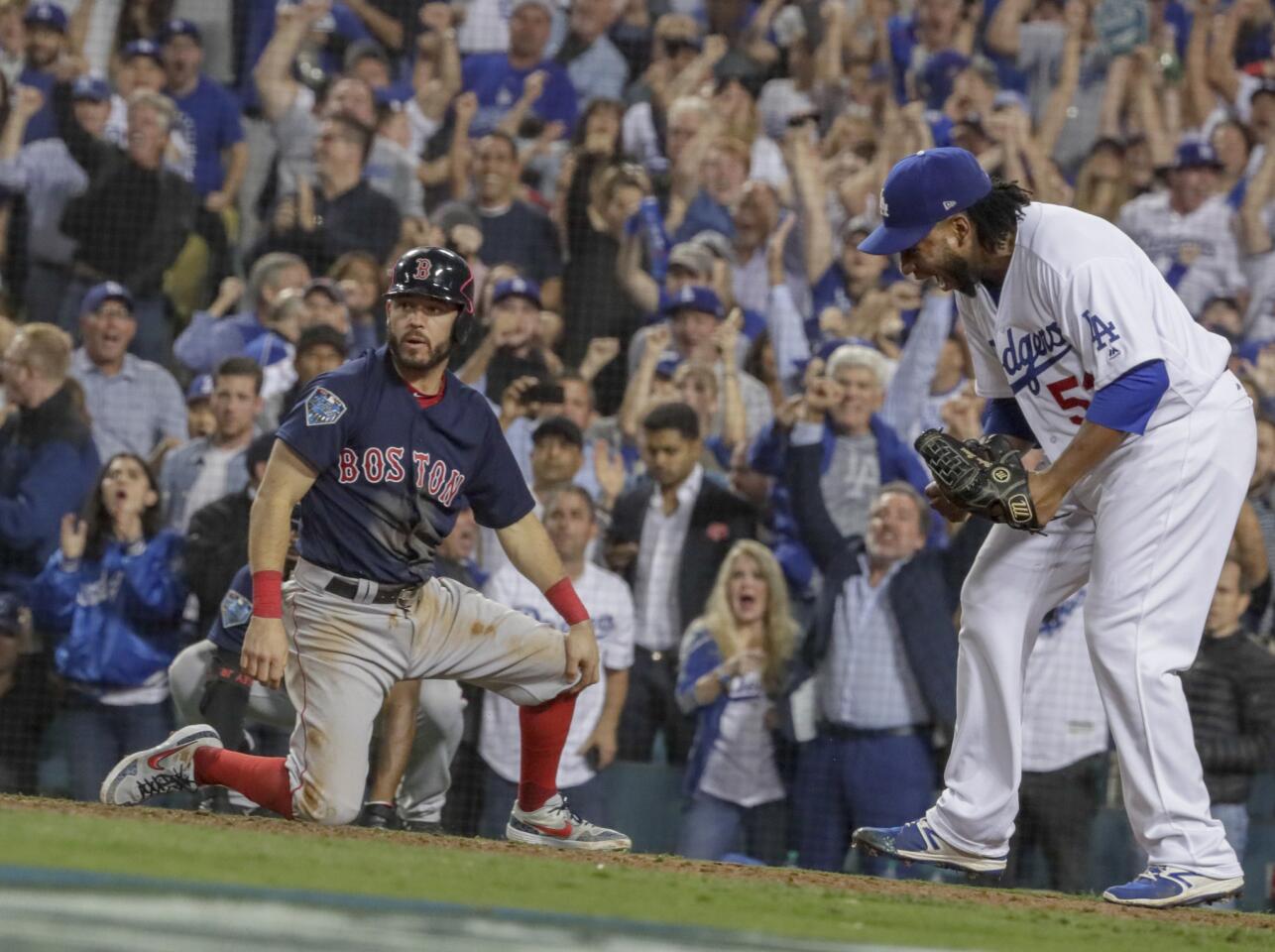 Pedro Baez celebrates after Ian Kinsler is thrown out at home tp end the top of the tenth inning.