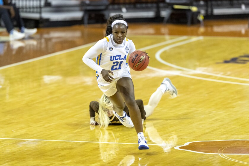 UCLA forward Michaela Onyenwere steals the ball and scores during the Bruins' 69-48 victory over Wyoming.
