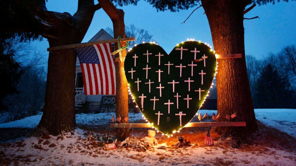 A memorial with crosses for the victims of the Sandy Hook Elementary School massacre stands outside a home on Dec. 14, 2013, the first anniversary of the tragedy in Newtown, Conn.