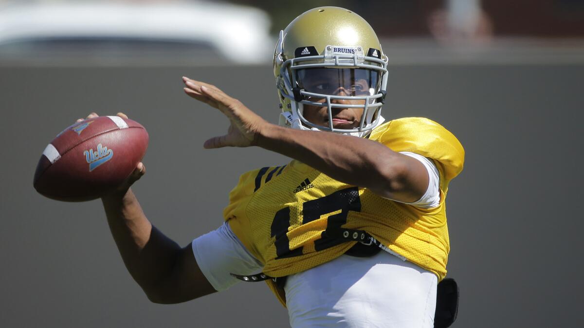 UCLA quarterback Brett Hundley throws a pass during a team practice session Wednesday. Hundley isn't shy when it comes to his Heisman Trophy aspirations and where he sees his place in UCLA football history.