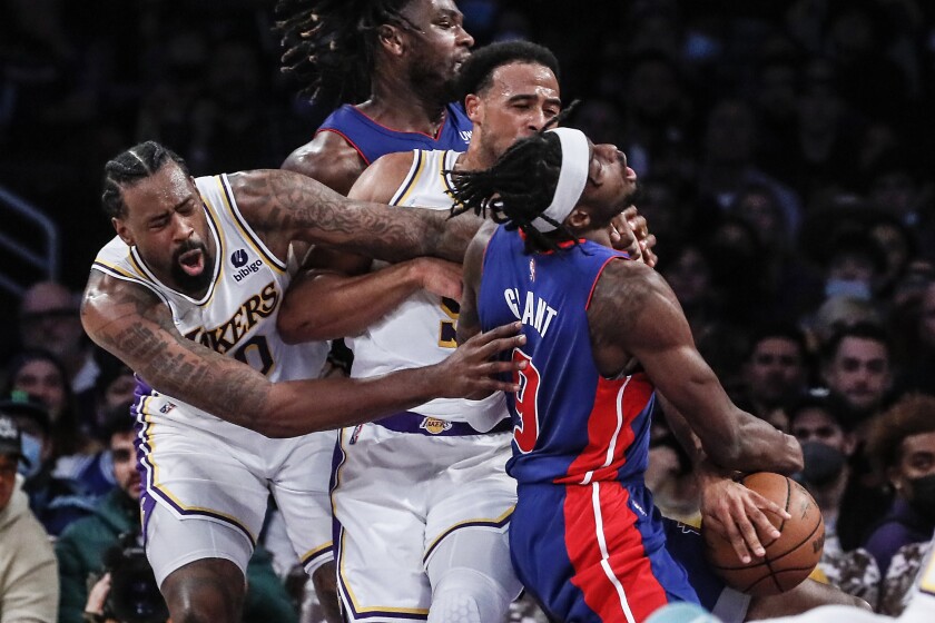 Detroit forward Jerami Grant is fouled by Lakers guard Talen Horton-Tucker as center DeAndre Jordan tries to get to the ball.