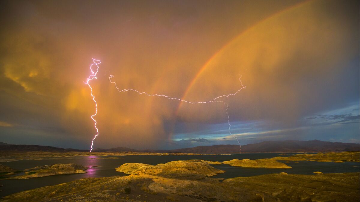 Lightning strikes as a rainbow arches over Lake Mead, which straddles Nevada and Arizona. The lake's water level has dropped almost 1,000 feet in just 17 years as the area is plagued by drought.