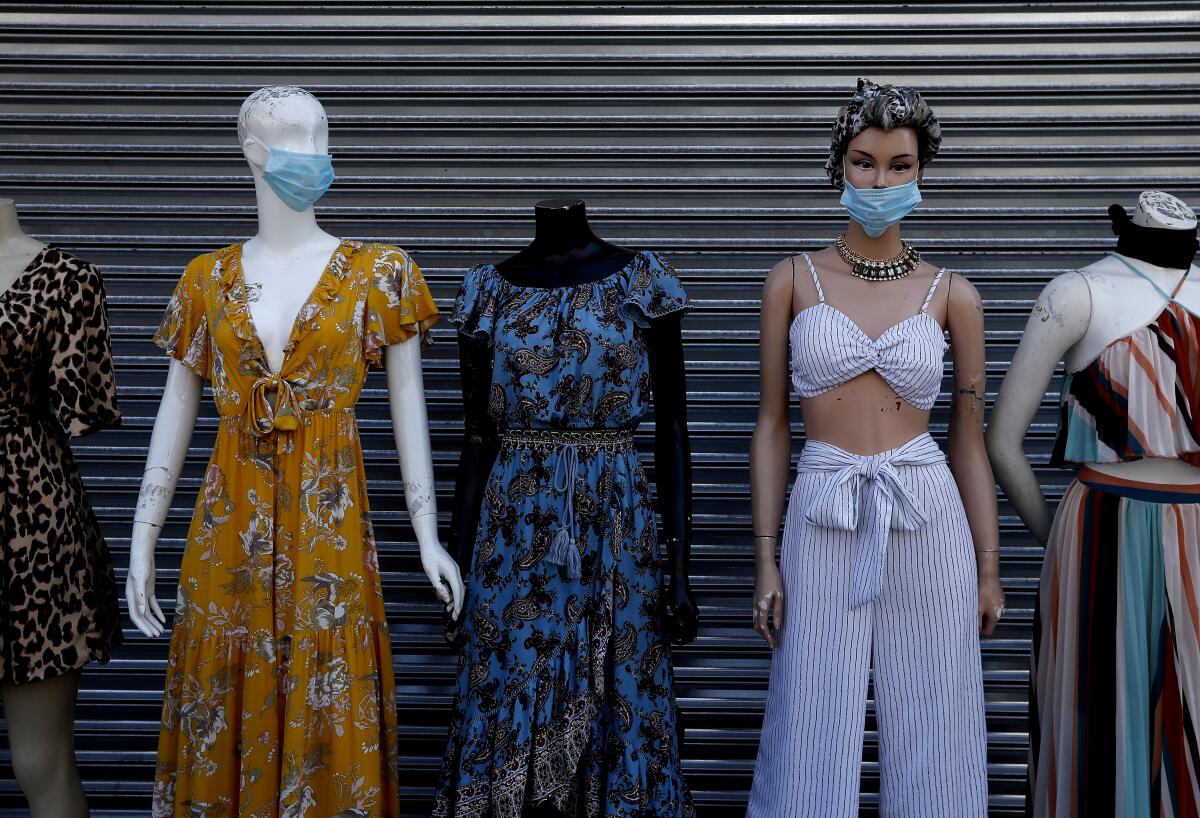 Mannequins wear protective masks in the garment district in downtown Los Angeles.