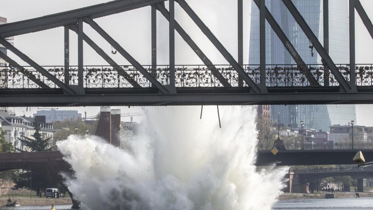 A large plume of water blasts up behind the Iron Bridge on the Main River in Frankfurt, Germany, after a 500-pound American bomb from World War II was detonated Sunday.