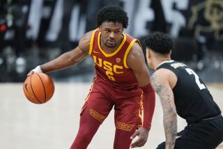 USC guard Bronny James, left, controls the ball in front of Colorado guard KJ Simpson.