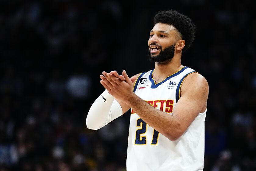 Denver Nuggets guard Jamal Murray gestures to teammates during the first quarter of the team's NBA basketball game against the Houston Rockets, Wednesday, Nov. 30, 2022, in Denver. (AP Photo/Jack Dempsey)