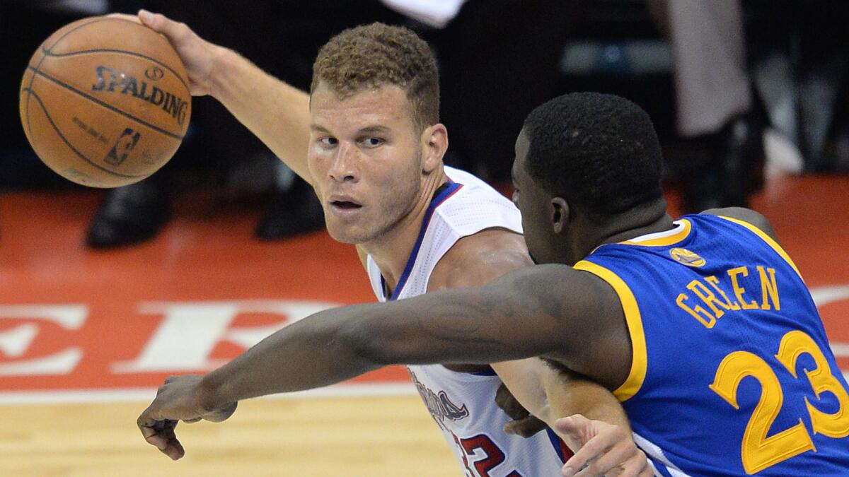 Clippers star Blake Griffin protects the ball from Golden State's Draymond Green during a playoff game in April. Griffin is being cautious with his back injury in order to make sure he's ready for the start of the season.