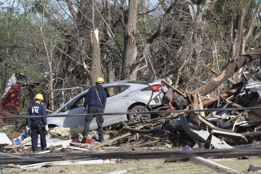 Wichita firefighters search what's left of John's Animal World on Saturday, April 30, 2022 in Andover, Kan. A suspected tornado that barreled through parts of Kansas has damaged multiple buildings, injured several people and left more than 6,500 people without power. (Jaime Green /The Wichita Eagle via AP)