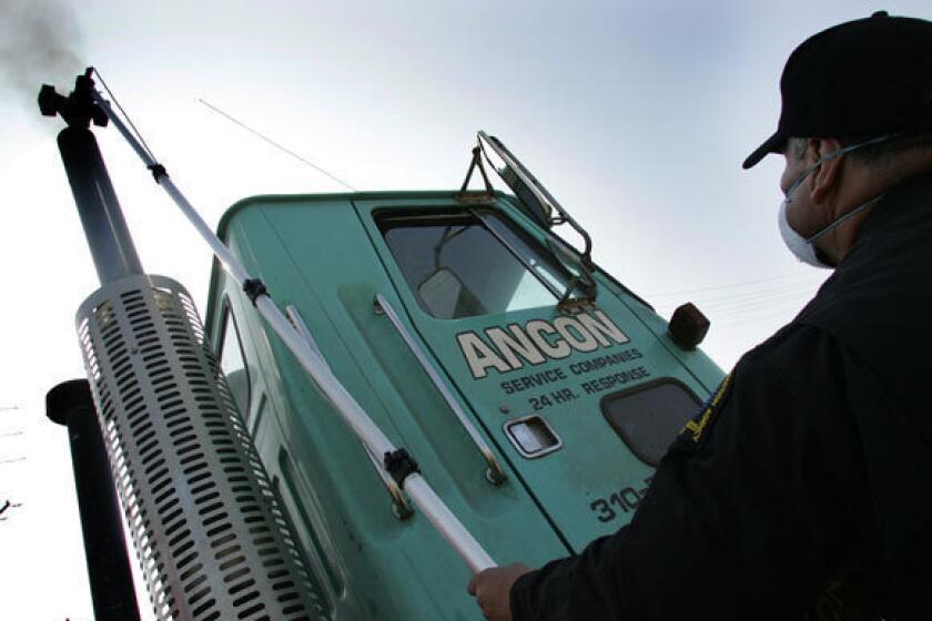 In this 2006 photo, California Air Resources Board inspector Paul Leon prepares to test the emissions of a diesel truck. This week the World Health Organization classified diesel exhaust as a carcinogen, linking it to lung and other cancers.