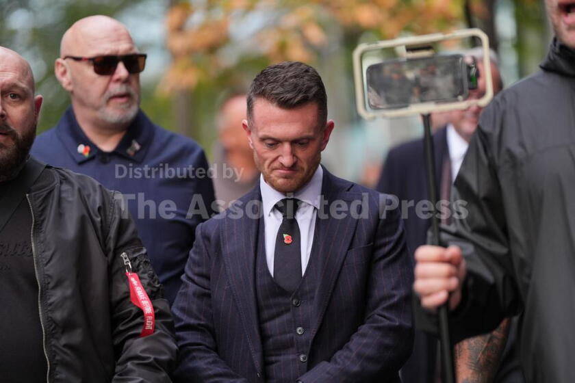 Stephen Yaxley-Lennon, the far-right British activist also known as Tommy Robinson, departs Southwark Crown Court in south London, after he was found guilty of harassing journalists Wednesday, Oct. 28, 2026. (Yui Mok/PA via AP)