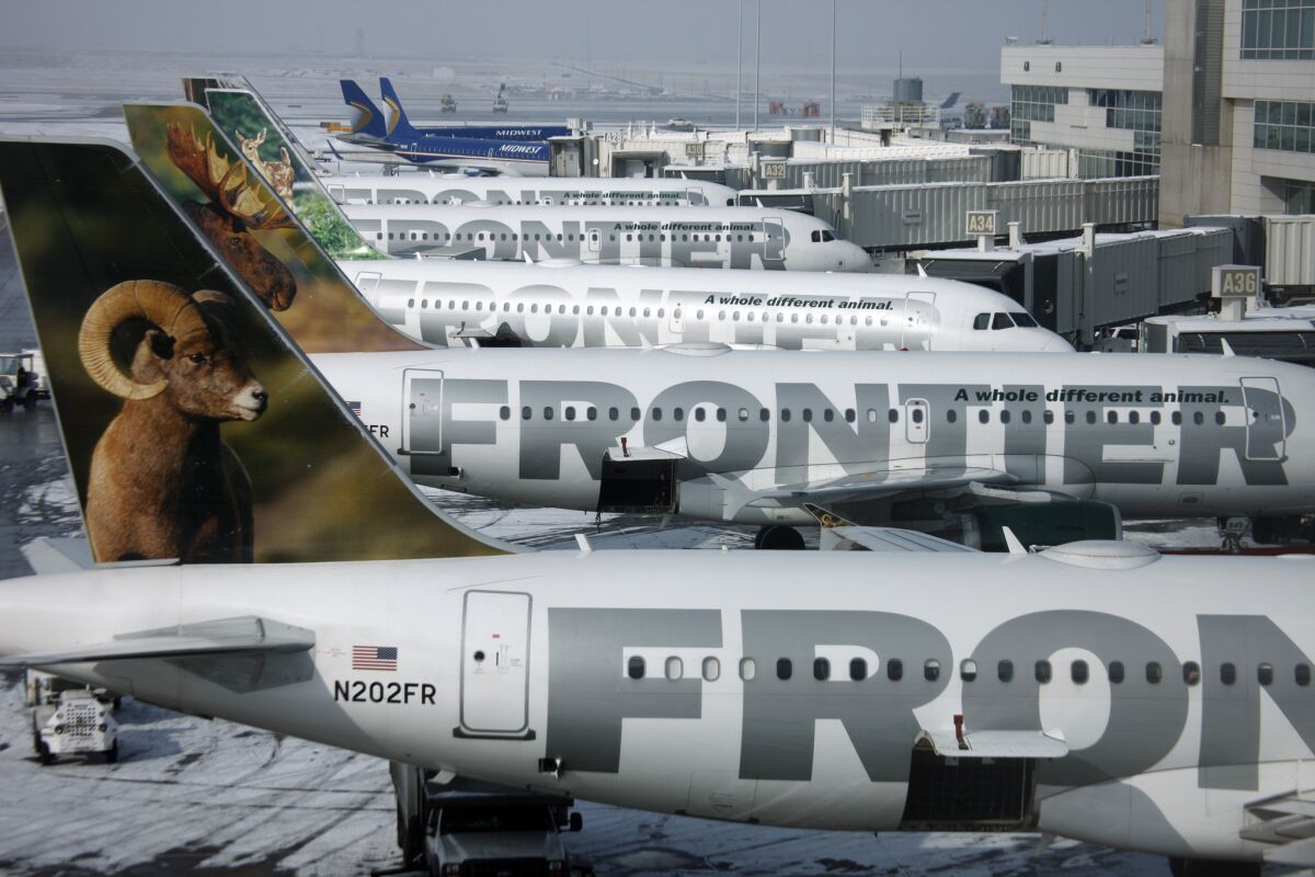 Frontier Airlines jetliners sit at gates at Denver International Airport in 2010. A nurse who tested positive for Ebola flew Frontier Airlines from Dallas to Cleveland and back.