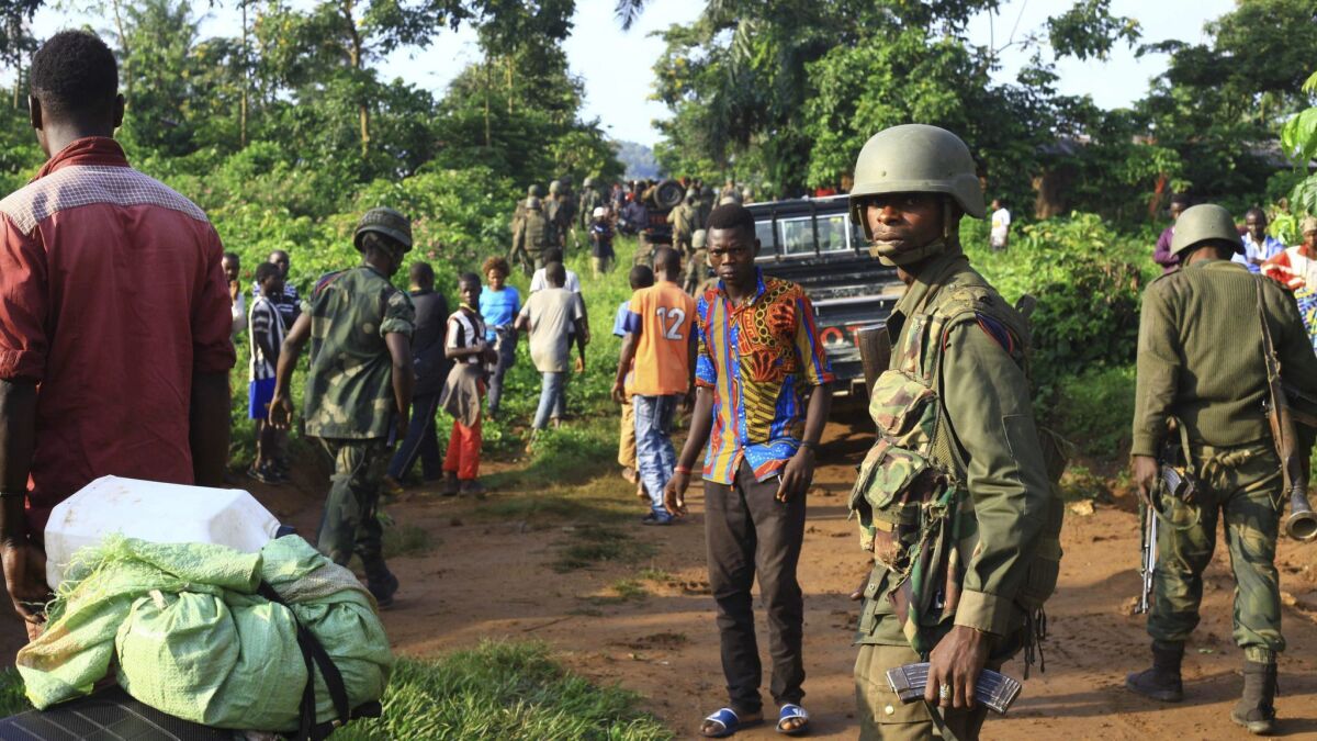 In this photo taken Oct. 5, Congolese soldiers patrol in an area civilians were killed by the Allied Democratic Forces rebels in Beni, Eastern Congo.