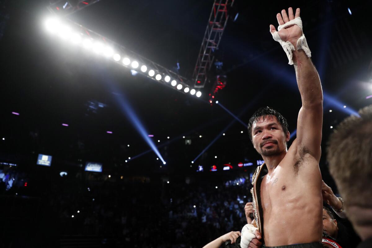 Manny Pacquiao, of the Philippines, celebrates after defeating Jessie Vargas in a WBO welterweight title boxing match Saturday, Nov. 5, 2016, in Las Vegas. (AP Photo/Isaac Brekken)
