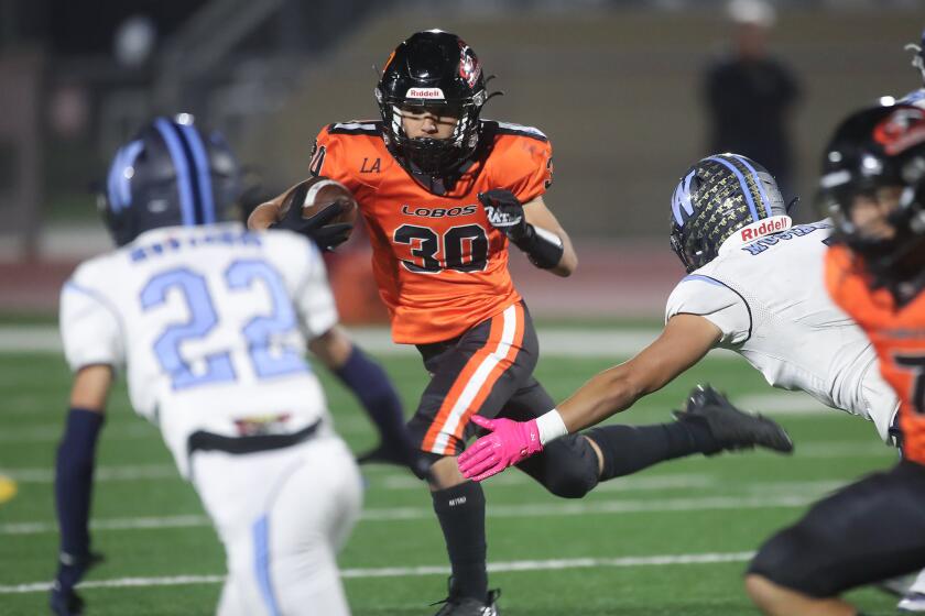 Receiver Isaac Galindo (30) runs for a gain during CIF Southern Section Division 13 football playoff game.