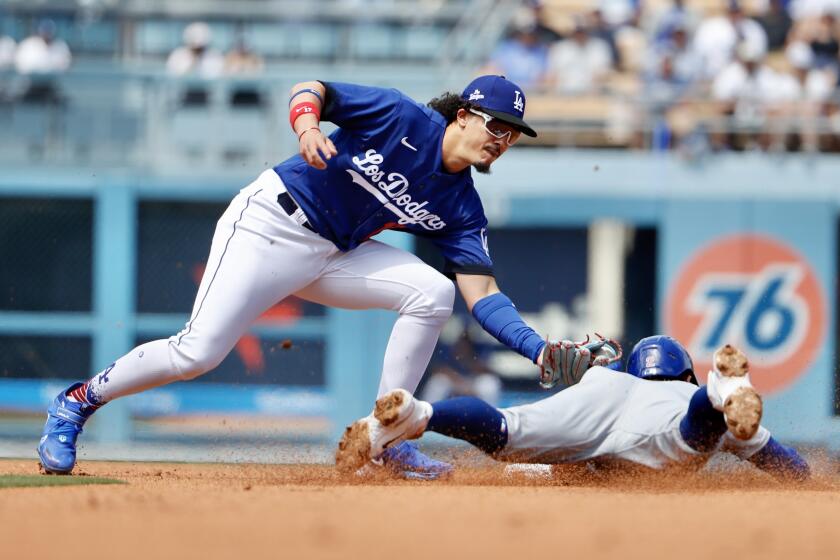 Los Angeles, CA - April 16: Dodgers' Miguel Vargas tags out Chicago Cubs' Nico Hoerner on a steal attempt.