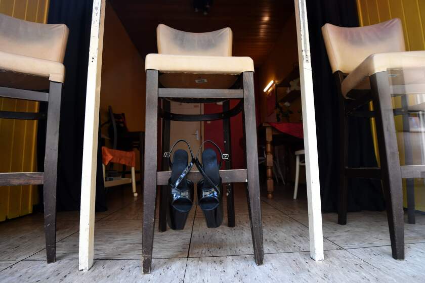 Shoes hang on a bar stool in a closed brothel on March 17, 2020 in Dortmund, western Germany, where many activities came to a halt due to the novel coronavirus. (Photo by Ina FASSBENDER / AFP) (Photo by INA FASSBENDER/AFP via Getty Images)