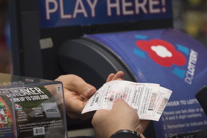 A man purchases a Powerball lottery ticket at a convenience store in Washington.