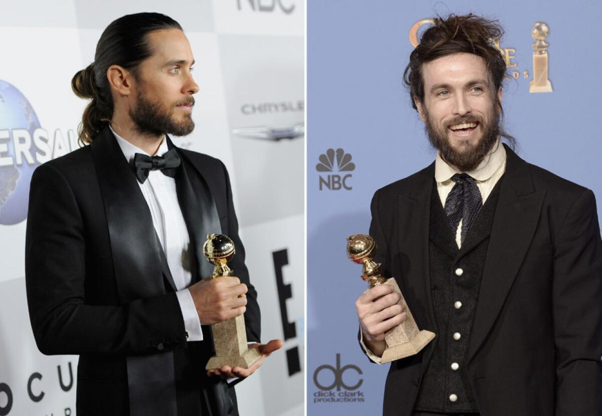 Both musician-actor Jared Leto, left, and musician Alex Ebert won in their categories, and both sported some eclectic man buns.