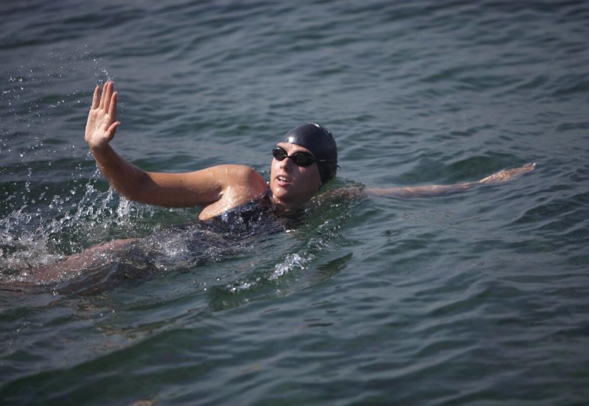 Chloe McCardel waves to spectators as she begins her swim to Florida from the waters off Havana, Cuba.