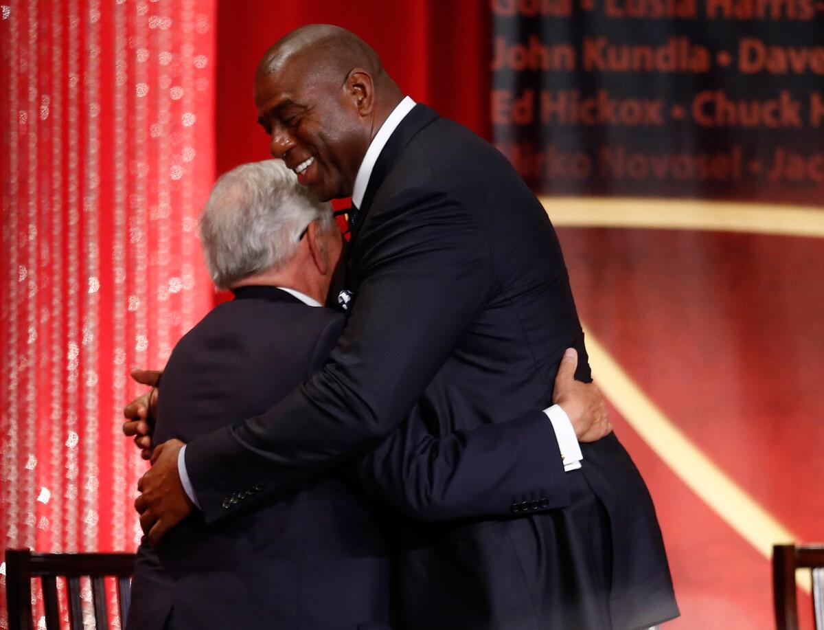 David Stern is hugged by Magic Johnson during the 2014 Basketball Hall of Fame enshrinement ceremony in Springfield, Mass.