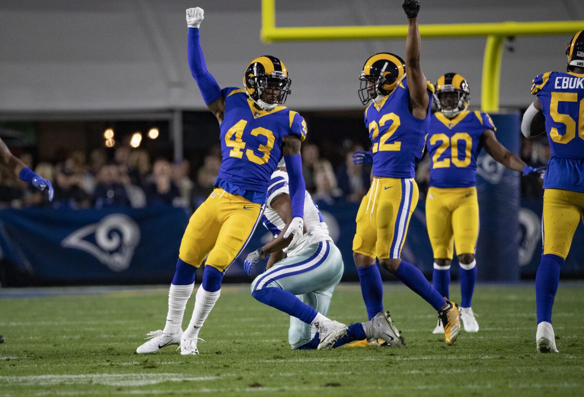 Rams strong safety John Johnson (43) and cornerback Marcus Peters (22) react after a defensive stop on the Dallas Cowboys on Saturday at the Coliseum.