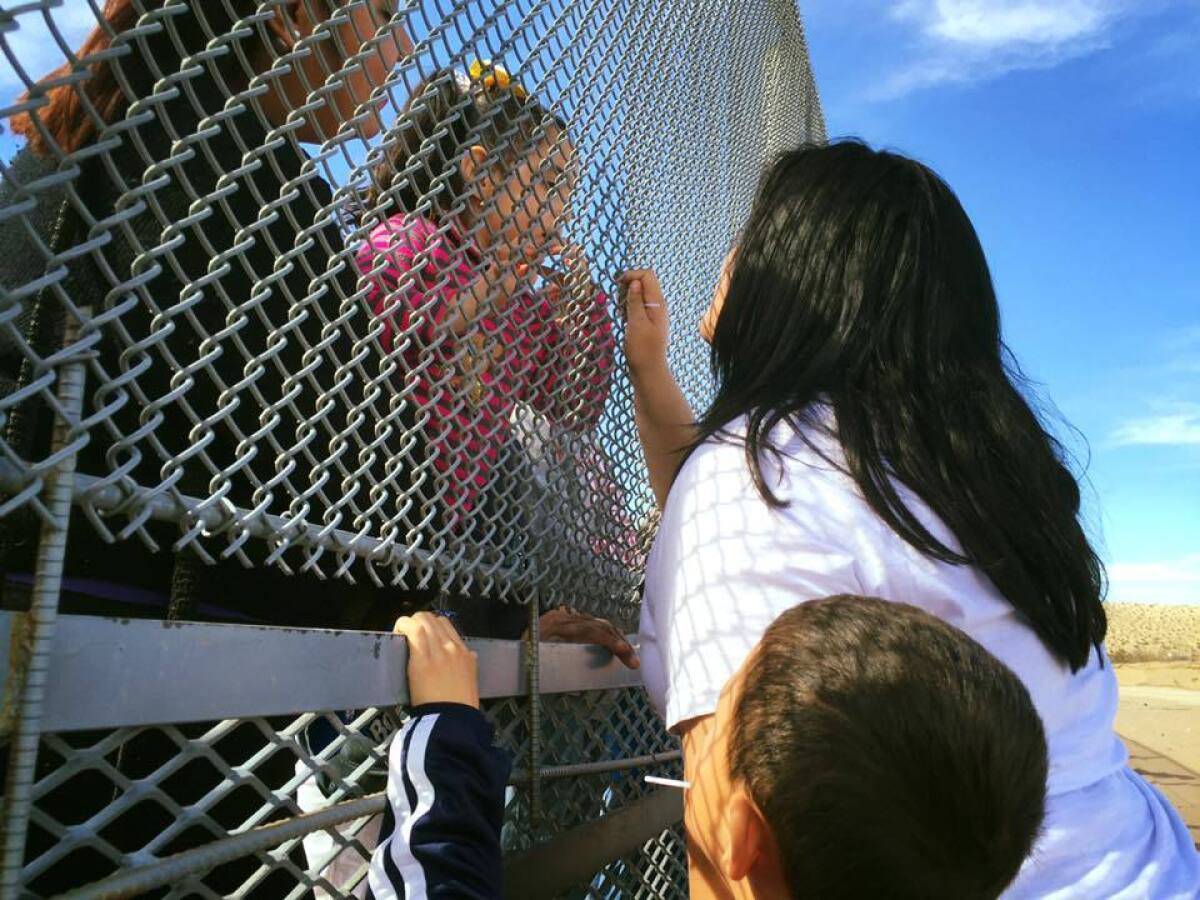 The aunt on the U.S. side, Valeria Montes, begs her niece on the Mexico side for a kiss. "Un beso!"