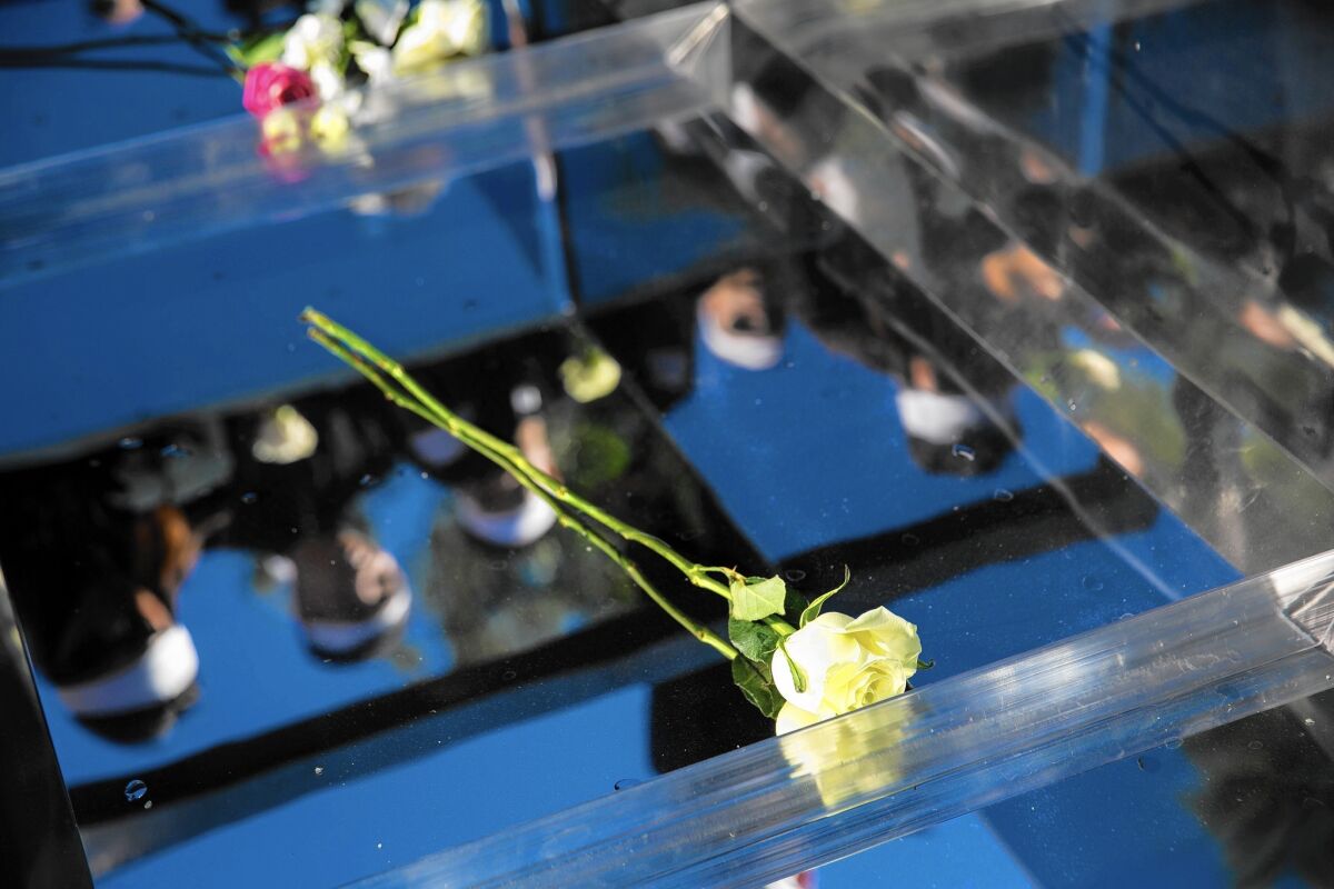 Flowers are placed in the burial vault in Huntington Beach on Saturday at the funeral for Tin Nguyen, 31, one of the victims of the deadly San Bernardino terrorist attack.