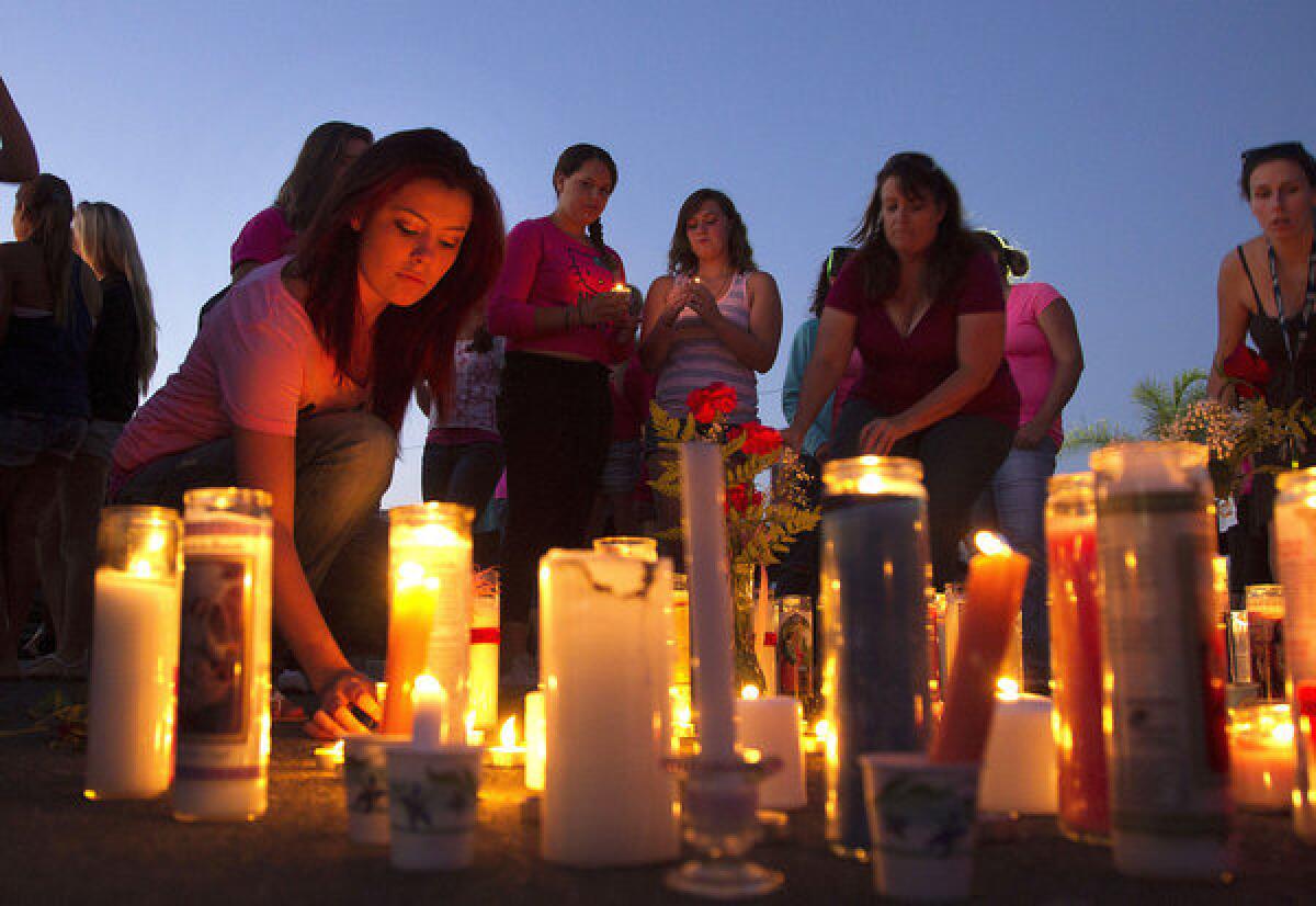 Athena Stewart lights a candle during a vigil at El Capitan High School in Lakeside, Calif. Missing teen Hannah Anderson is a student at the school.