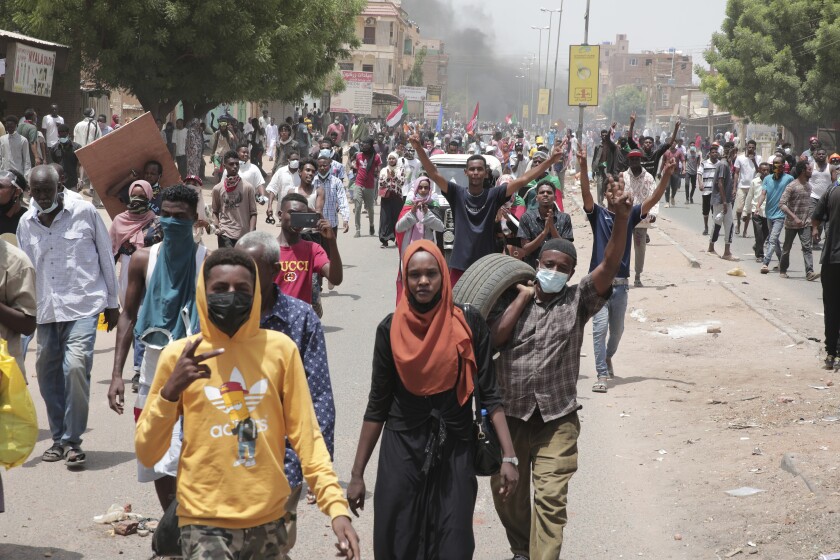 Sudanese anti-military protesters march in demonstrations in the capital of Sudan, Khartoum, on Thursday, June 30, 2022. A Sudanese medical group says multiple people were killed on Thursday in the anti-coup rallies during which security forces fired on protesters denouncing the country’s military rulers and demanding an immediate transfer of power to civilians. (AP Photo/Marwan Ali)