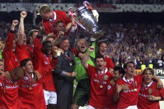 FILE - Manchester United's Gary Neville, second right, his brother Phil Neville, right, and the players celebrate with the trophy after wining the UEFA Champions Cup final, beating Bayern Munich 2-1, at the Nou Camp Stadium in Barcelona, Wednesday, May 26, 1999. Gary Neville says he is in fear ahead of the FA Cup final between Manchester United and Manchester City. He was a part of United’s treble-winning team of 1999 when it became the only English soccer team to win the three major trophies in a single season. (AP Photo/Camay Sungu, File)