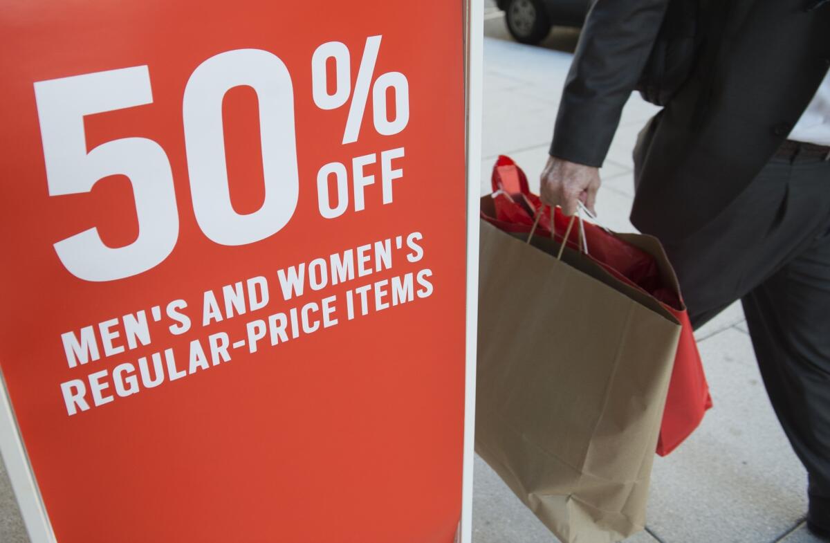 A man carrying shopping bags Tuesday at a Gap store in Washington, D.C.