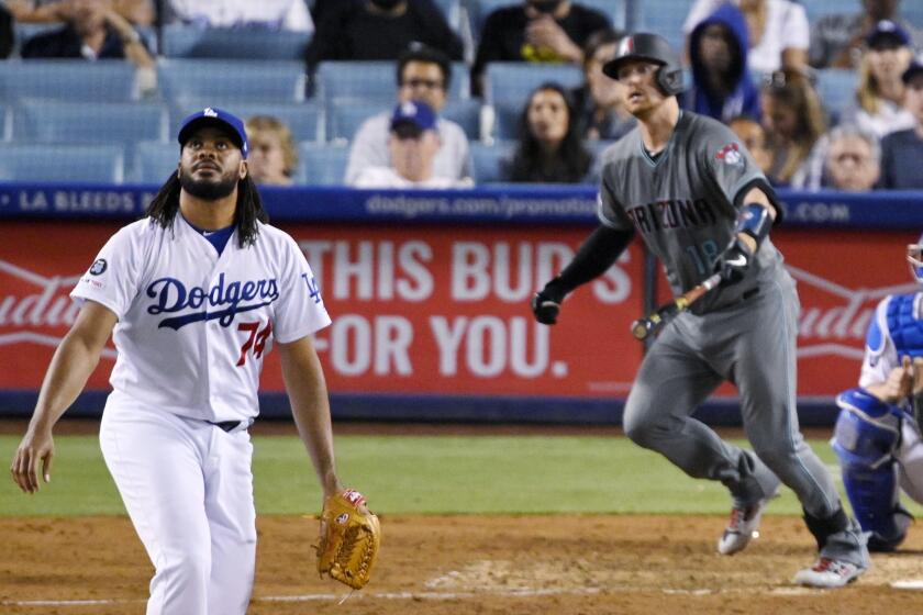 Los Angeles Dodgers relief pitcher Kenley Jansen turns to watch a two-run home run by Arizona Diamondbacks' Carson Kelly during the ninth inning of a baseball game Friday, Aug. 9, 2019, in Los Angeles. (AP Photo/Mark J. Terrill)