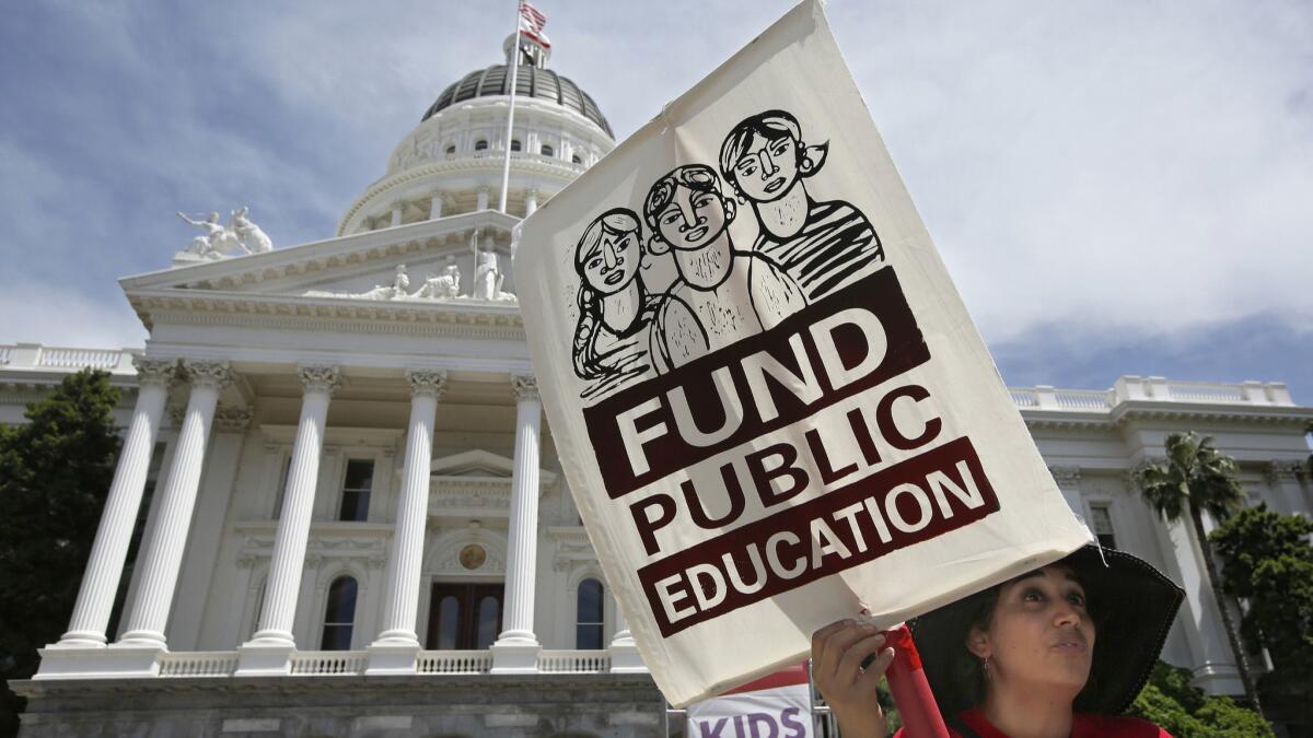 Mayra Joseph, a teacher at Sylvia Mendez Elementary School in Berkeley, joins members of the California Teachers Assn. and supporters of public education in a march to the Capitol as part of “RedForEd Day of Action” on Wednesday in Sacramento.