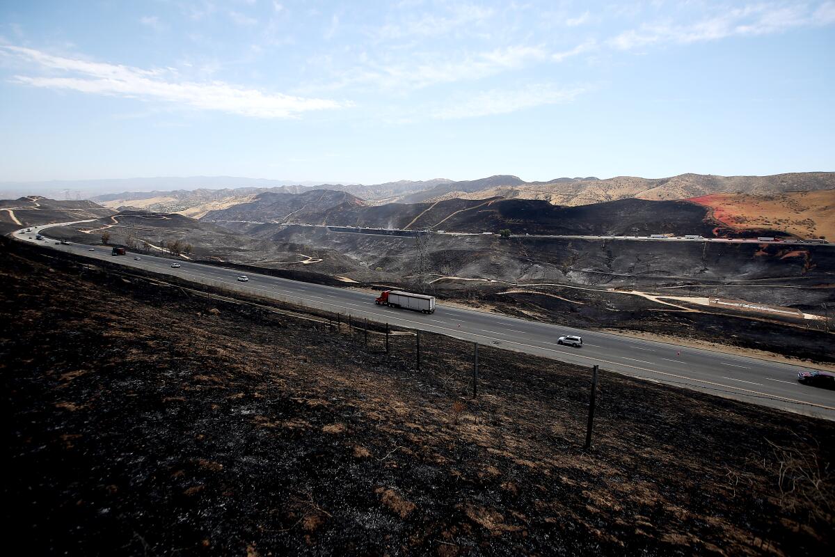 The hills around Interstate 5 near Castaic are blackened from the Route Fire on Sept. 1. 