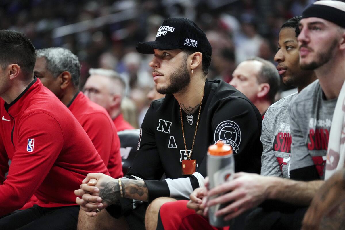 Bulls' Lonzo Ball sits on the bench during a basketball game against the Clippers