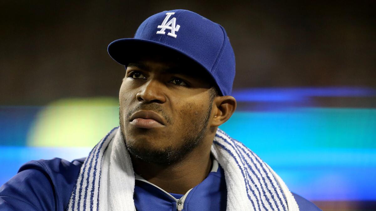 Dodgers outfielder Yasiel Puig watches the action from the dugout during a game against the Rockies on Sept. 15.