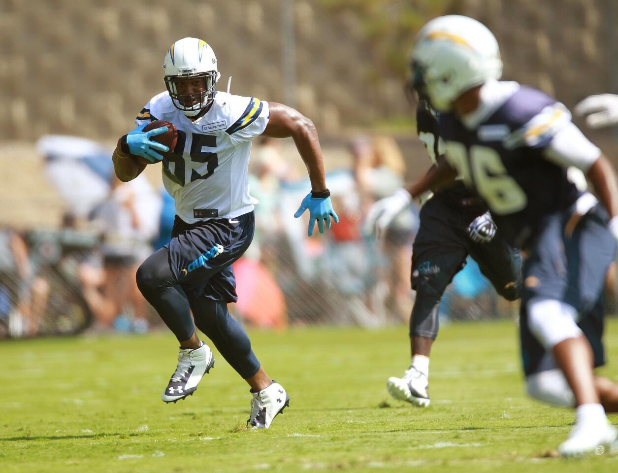 Antonio Gates runs into the clear on the field at Chargers Park on the first day of camp.