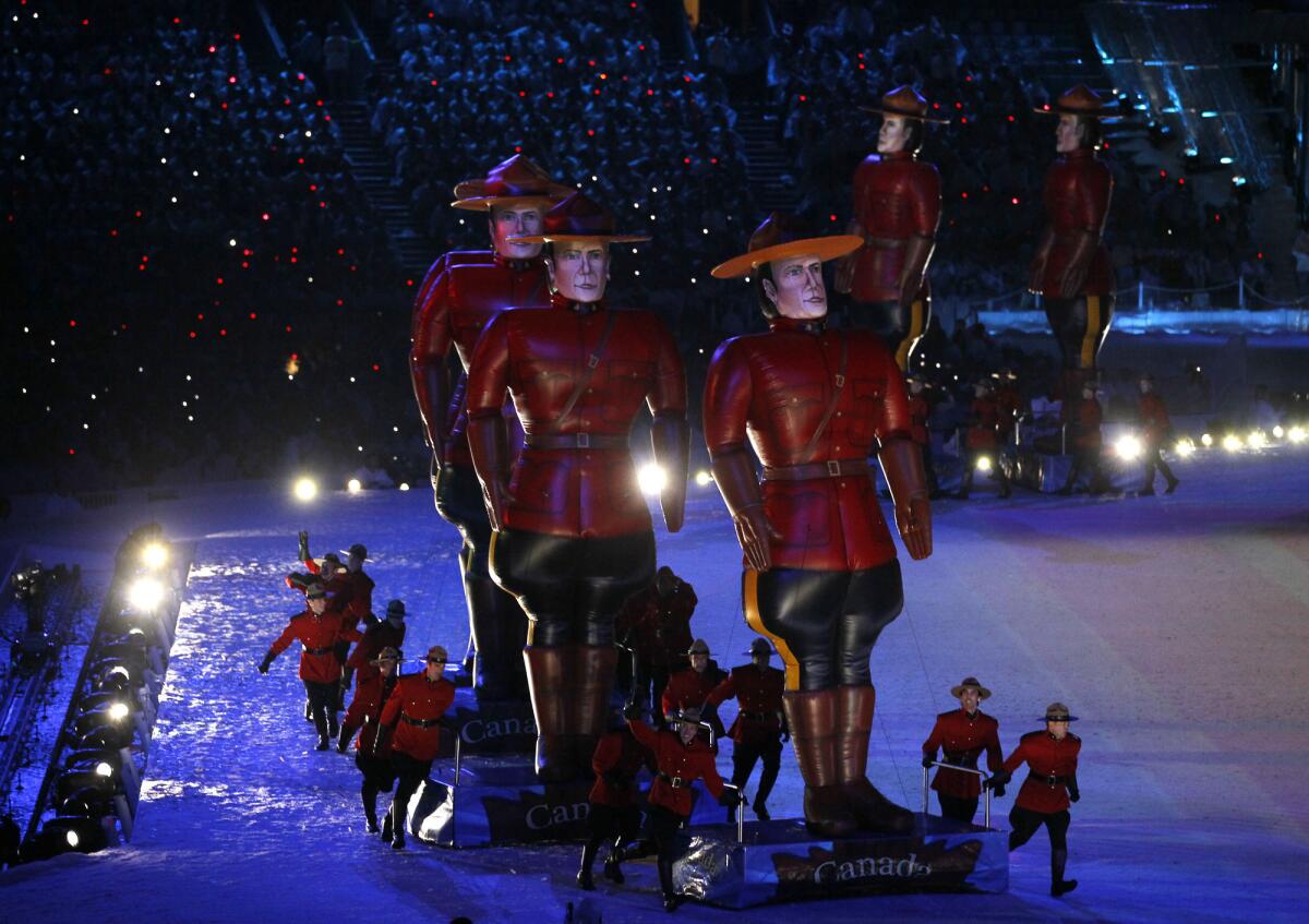 Inflatable gigantic Royal Canadian Mounted Police constables are pushed around by dancers dressed as Mounties during the Vancouver Olympics closing ceremony in February 2010.