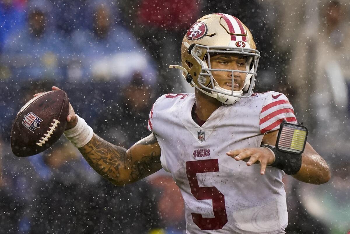 San Francisco 49ers' Trey Lance throws in the rain during the second half of an NFL football game against the Chicago Bears Sunday, Sept. 11, 2022, in Chicago. (AP Photo/Nam Y. Huh)