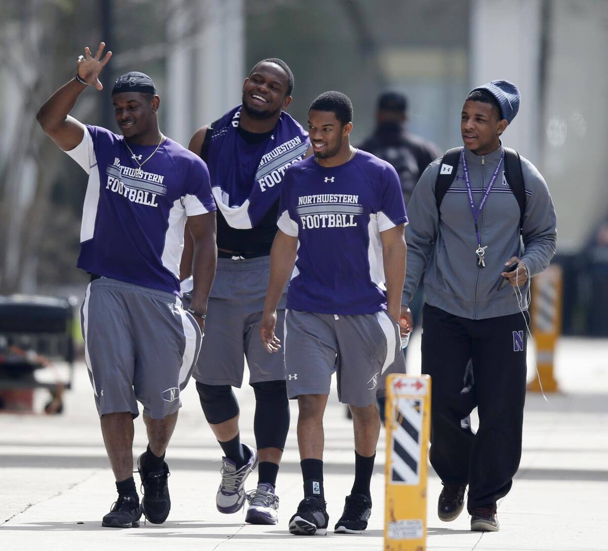 Northwestern football players walk to McGaw Hall, where voting is taking place on whether they should unionize.