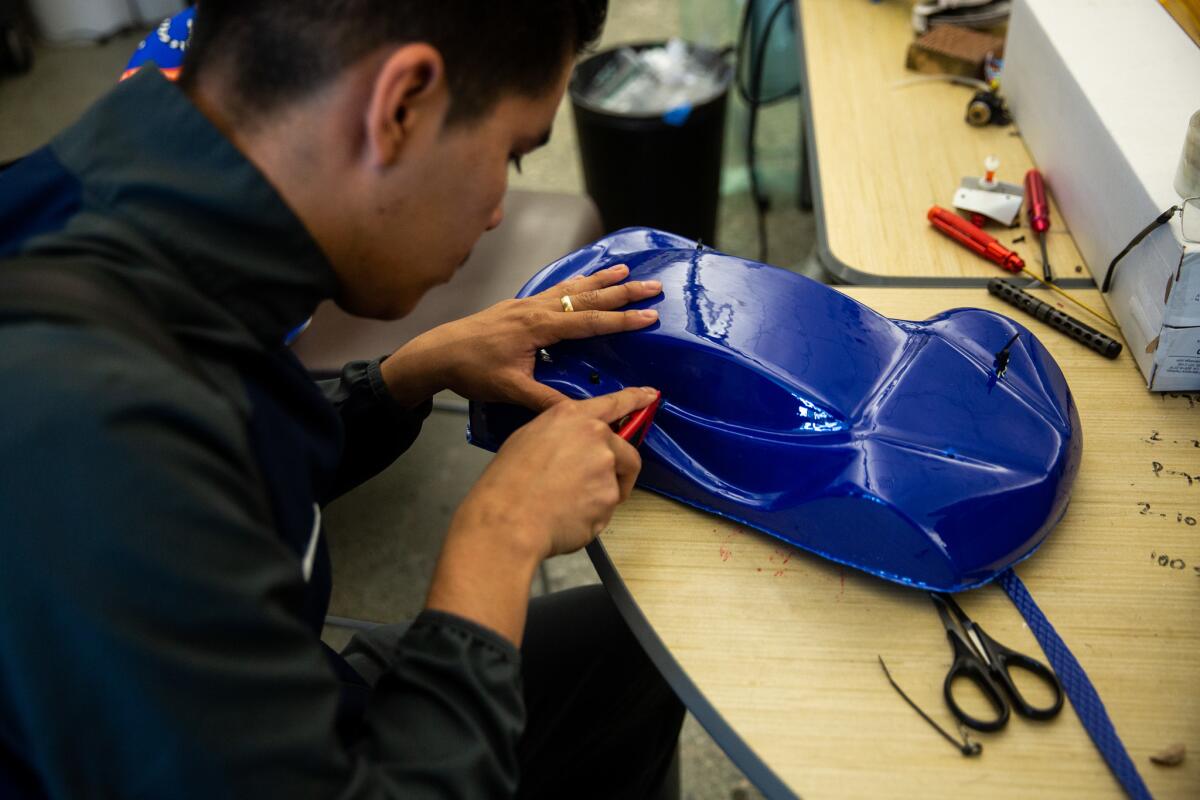 Ismael Zenteno, 17, of South Gate, works on the shell of a hydrogen-powered car in Mario Ibarra's class at STEAM Legacy High School.