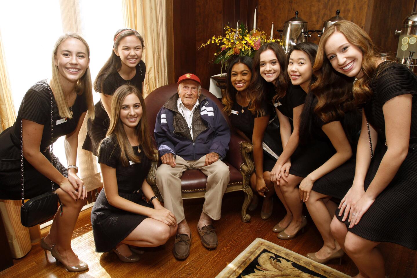 American war hero, World War II prisoner of war and olympian Louis Zamperini, center, was chosen as the Grand Marshal for the 2015 tournament of Roses, in Pasadena on Friday, May 9, 2014. Above, Zamperini enjoys a moment with the 2014 Royal Court at the Tournament House in Pasadena.