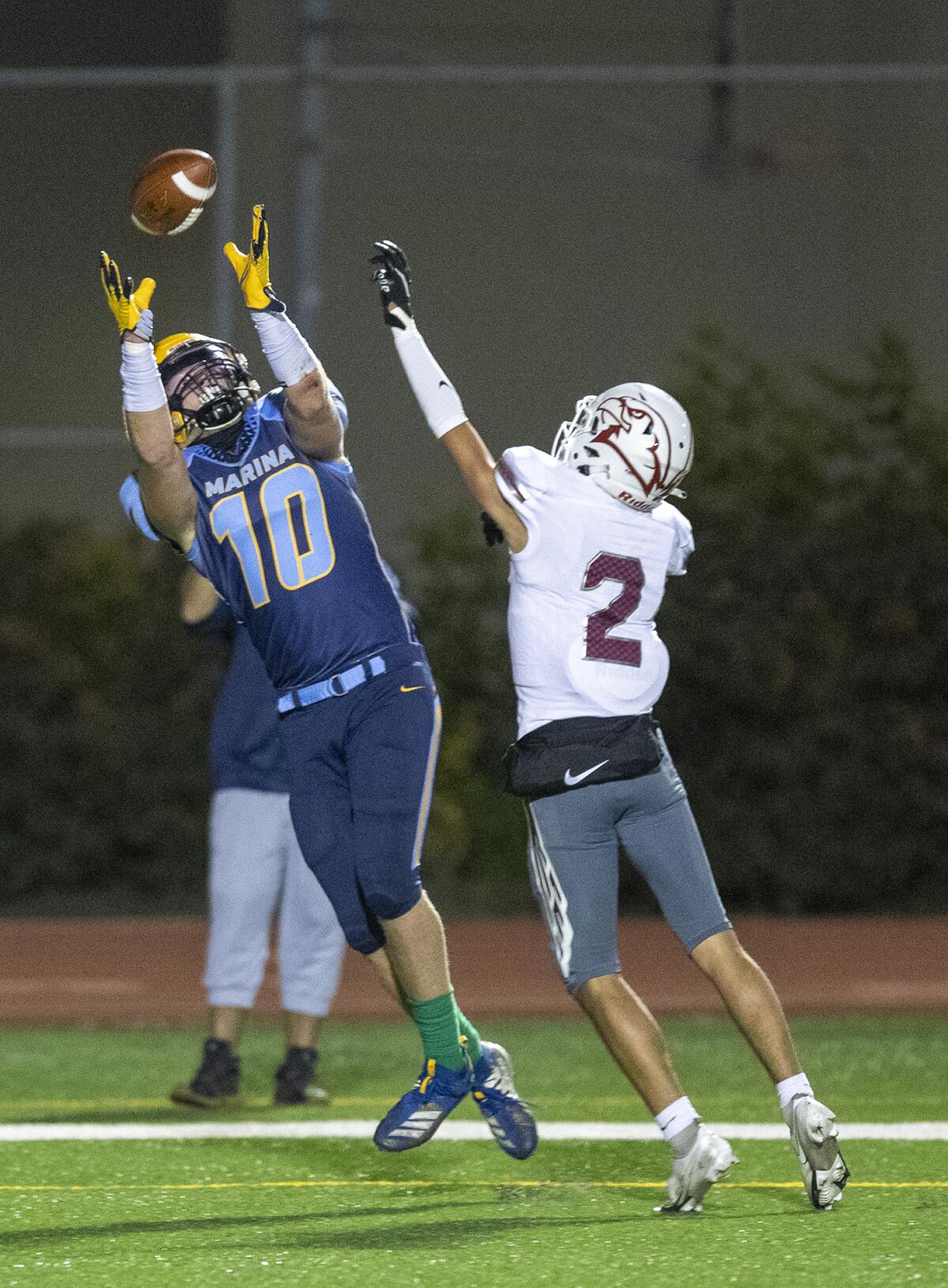 Marina's Wyatt McClour catches a pass in the second quarter over Ocean View's Cash Schnekenburger.