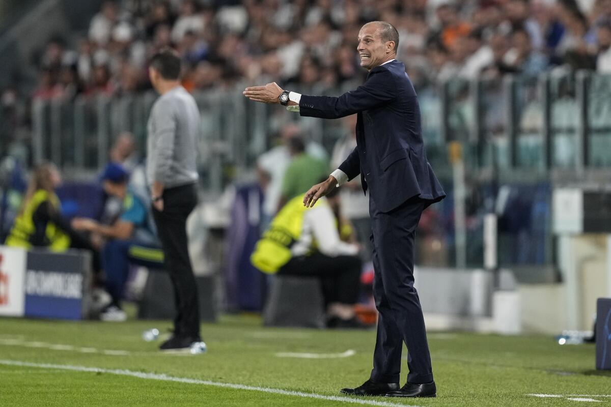 Juventus' head coach Massimiliano Allegri gives instructions to his players during a Champions League group H soccer match between Juventus and Benfica at the Allianz stadium,Turin, Italy, on Wednesday, Sept. 14, 2022. (AP Photo/Antonio Calanni)