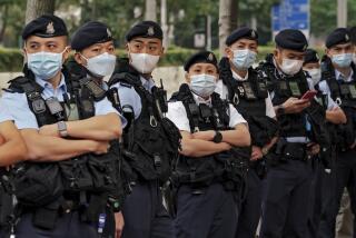 Policemen wearing face masks stand guard outside the West Kowloon Magistrates' Courts ahead of the national security trail for the pro-democracy activists in Hong Kong, Monday Feb. 6, 2023. Some of Hong Kong's best-known pro-democracy activists went on trial Monday in the biggest prosecution yet under a law imposed by China's ruling Communist Party to crush dissent. (AP Photo/ Anthony Kwan)