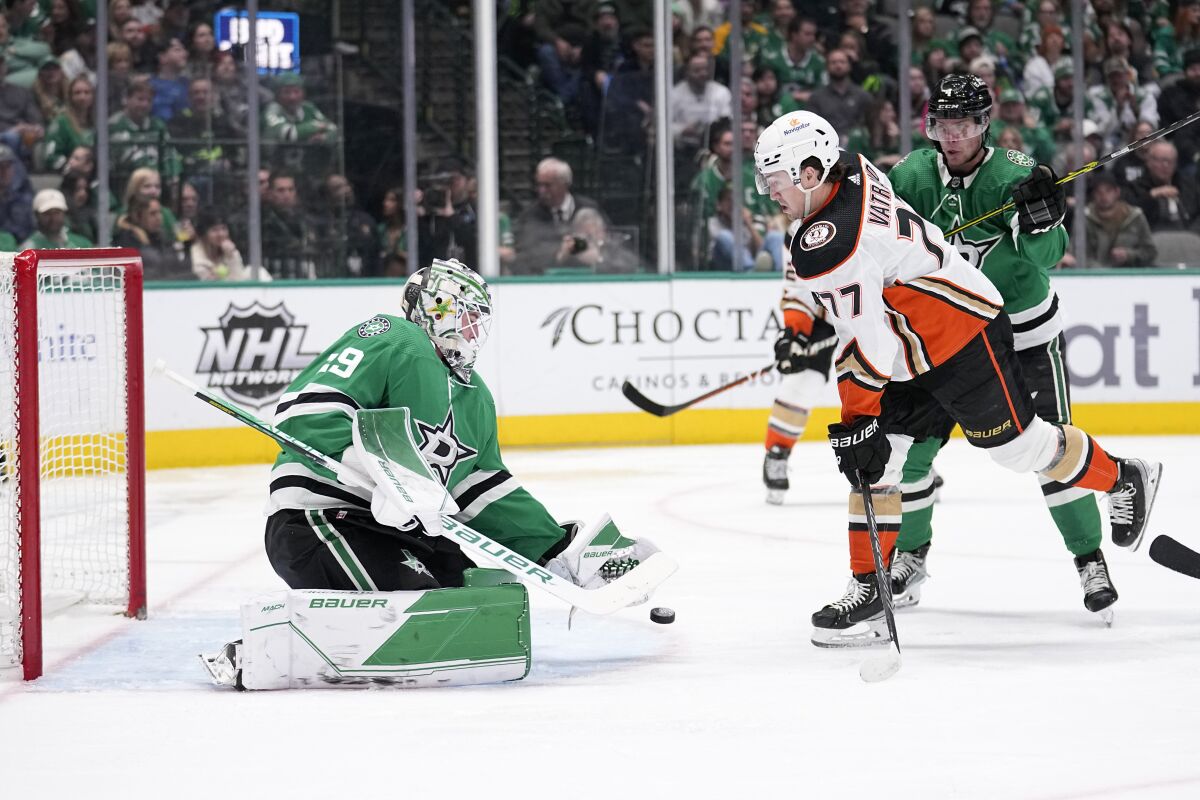 Dallas Stars goaltender Jake Oettinger defends against a shot while under pressure from Ducks right wing Frank Vatrano.
