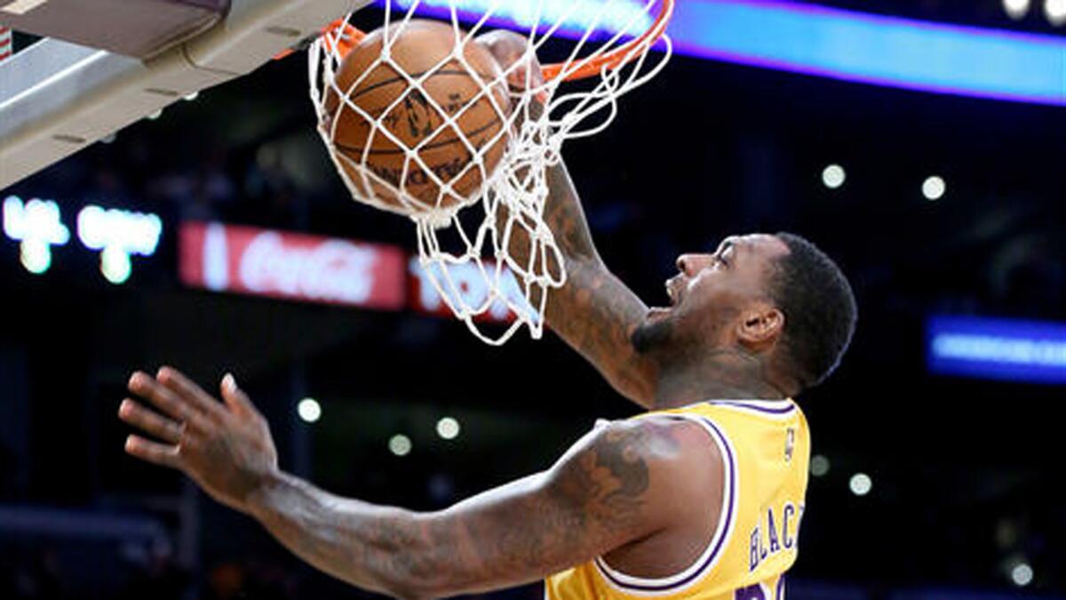 Lakers center Tarik Black throws down a dunk against the Warriors during a game last week.